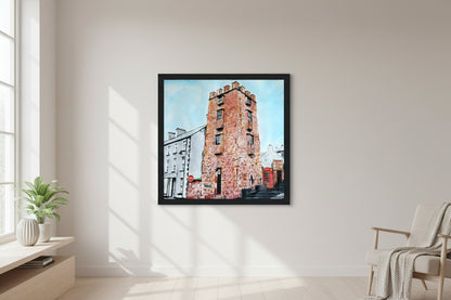 30×30 cm black-framed square art print of The Curfew Tower Cushendall hanging on a soft-neutral wall, modern minimalist living room, natural light, subtle shadows, clean Scandinavian décor, crisp frame detail, premium editorial home-styling photography. Framed art print 'The Curfew Tower' by Ó Maoláin. This piece depicts The Curfew Tower in Cushendall, Glens of Antrim, built by Francis Turnley in 1820 and now owned by Bill Drummond. The artwork showcases the tower amid the scenic Glens of Antrim.